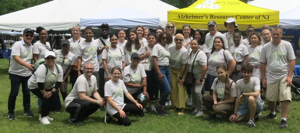 A group of Act Now Foundation volunteers smiling together at the Brain Health & Community Resource Fair, showing their commitment to supporting dementia awareness in New Jersey.